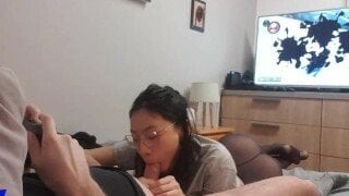 June Liu sucks the cock of her friend while he plays a video game
